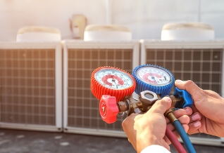 A technician holding an AC testing device.