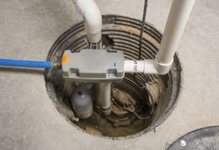 A sump pump in a basement floor.