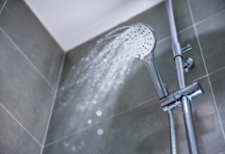 Hot water coming out of a shower head.