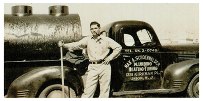 Max Sr. standing in front of the original service truck in the 1920s.