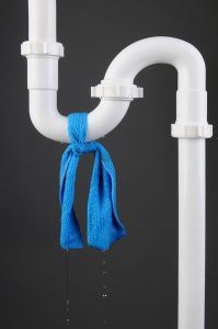 white pipe with blue cloth tied around it