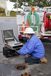 plumber-looking-at-screen-using-video-pipe-inspection