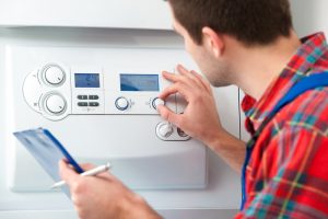 technician-adjusting-knobs-on-gas-boiler