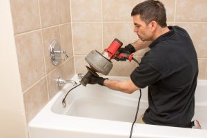 plumber-cleaning-drain-with-drain-snake