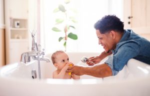 father-washing-infant-son-in-tub