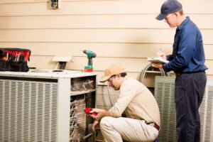 two-technicians-working-on-outdoor-ac-unit